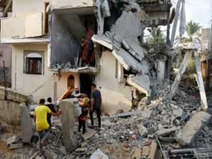 Palestinians carry out belongings from a damaged house in Gaza Strip (Image: ANI )